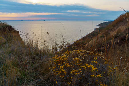 sunset seascape, sea, waves, view from high hillsの写真素材