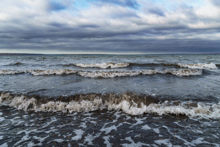 dramatic seascape, gloomy sea and waves, dark moody sky, wild landscape of late autumn, cloudy...