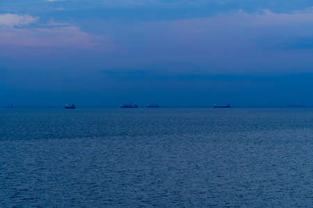 sunset, ships at sea, seascape with blue skyの写真素材