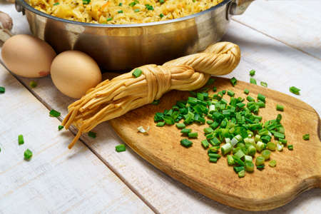 fried chopped cabbage in a frying pan, garlic and green onions, cheese and farm eggs, raw and cooked...