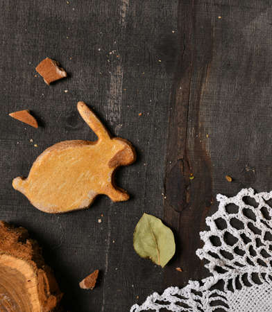 easter holiday still life and decorations, cookies in the shape of rabbit on dark wooden background,...