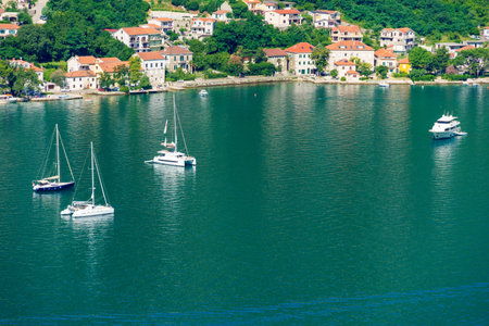 top view of the marina in Kotor, Montenegro, and the coast of the Bay of Kotor, the sea and European architecture, red tiled roofs, the concept of traveling in the Balkansの写真素材