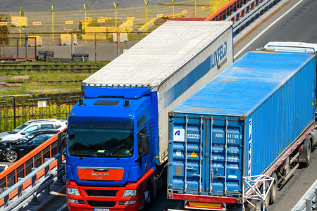 seaport, Odessa, Ukraine, May 4, 2019 - a truck transports a container, a view of a commercial industrial seaport, infrastructure, warehouses with containers, loading and unloading for international transportation by trucks and ships, a logistics hubのeditorial素材
