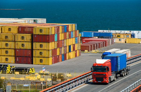 seaport, Odessa, Ukraine, May 4, 2019 - a truck transports a container, a view of a commercial industrial seaport, infrastructure, warehouses with containers, loading and unloading for international transportation by trucks and ships, a logistics hubのeditorial素材