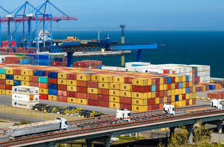 seaport, Odessa, Ukraine, May 4, 2019 - a truck transports a container, a view of a commercial industrial seaport, infrastructure, warehouses with containers, loading and unloading for international transportation by trucks and ships, a logistics hubのeditorial素材
