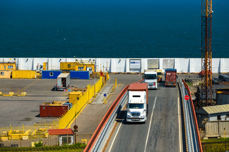 seaport, Odessa, Ukraine, May 4, 2019 - a truck transports a container, a view of a commercial industrial seaport, infrastructure, warehouses with containers, loading and unloading for international transportation by trucks and ships, a logistics hubのeditorial素材
