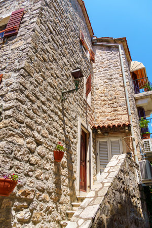 street view of the old town of Budva in Montenegro, medieval European architecture, city streets, windows with wooden shutters, red tiled roofs, the concept of traveling through the Balkansのeditorial素材