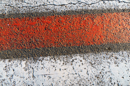 pedestrian crossing road markings, red and white lines on asphalt as backgroundの写真素材