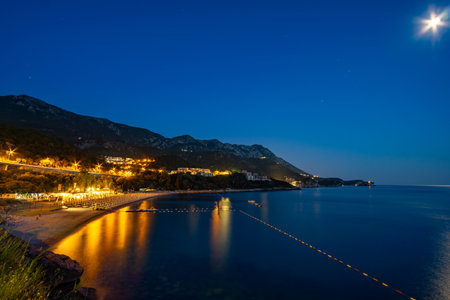 night view of beautiful seaside resort, sea and beach, city streets, adriatic sea, summer holiday backgroundの写真素材