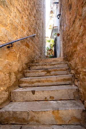 street view of the old town of Budva in Montenegro, medieval European architecture, narrow streets in historic city with steps, the concept of traveling through the Balkansの写真素材