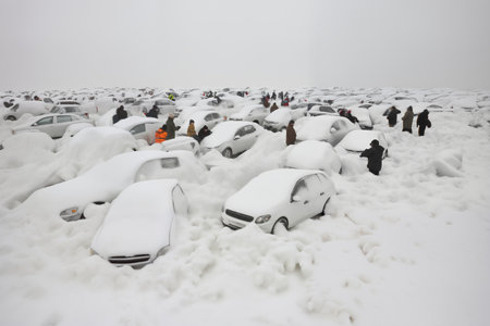 A bunch of cars stuck in a snowdrift on a winter road, a lot of snow, road safety concepts on a slippery roadの素材