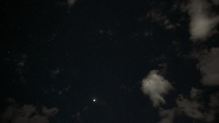 dark night sky with clouds and stars, space as background