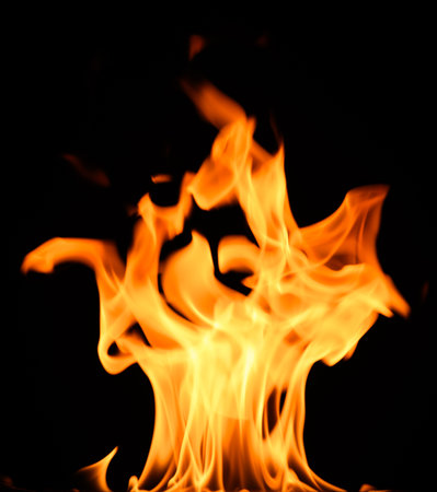 fire on a black background, burning and hot flames, close view