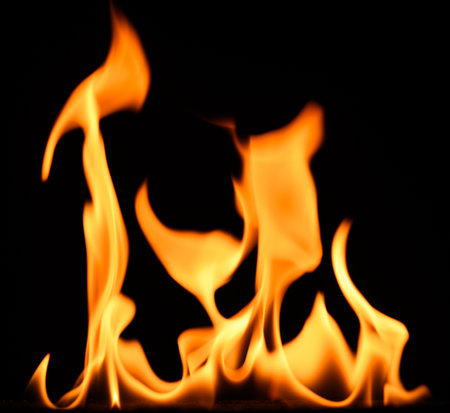 fire on a black background, burning and hot flames, close viewの写真素材