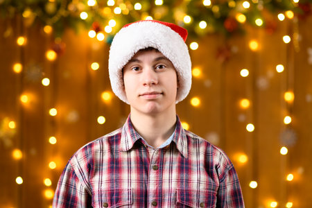 A teenage boy poses in the decorations for the New Year holiday, festive illumination and garland, decorationsの写真素材