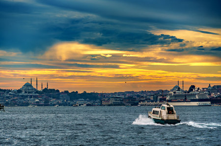 view from a pleasure boat on the Bosphorus and the cityscape of Istanbul, Turkey, the architecture of the city at sunset, a popular tourist destination.の写真素材