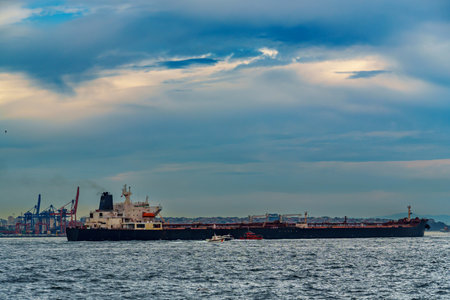 A large tanker ship sails along the Bosphorus against the background of Istanbul, Turkey, a view from a pleasure boatの写真素材