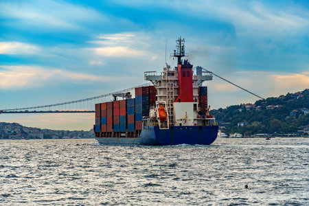 a large container ship sails along the Bosphorus, against the background of Istanbul, Turkey, a view from a pleasure boatの写真素材