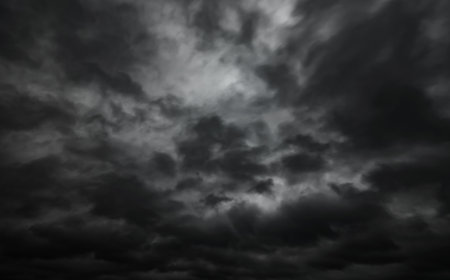 dark dramatic sky with black stormy clouds before rain as abstract background, extreme weather.の写真素材