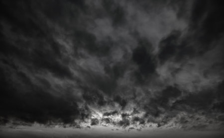 dark dramatic sky with black stormy clouds before rain as abstract background, extreme weather.の写真素材