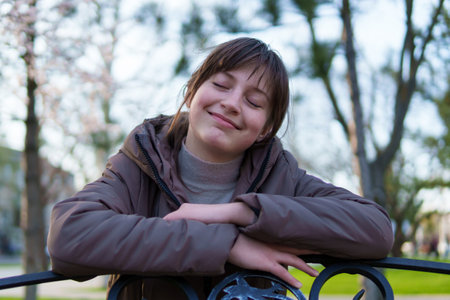 portrait of a teenage girl in a spring parkの写真素材