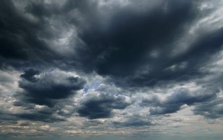 dark dramatic sky with black stormy clouds before rain as abstract background, extreme weather