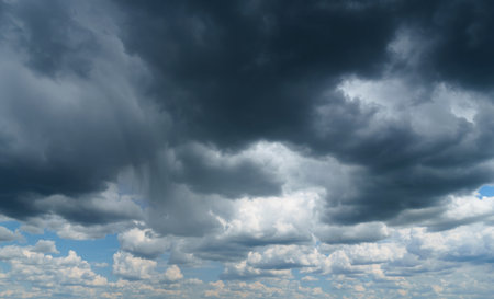 dark dramatic sky with stormy clouds before rain as abstract background, extreme weatherの写真素材