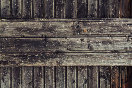 background of old weathered and cracked boards with peeling paint of brown color