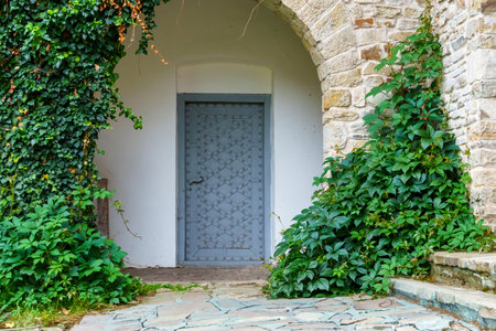 close up of architectural details, old stone wall with arch and doorの写真素材