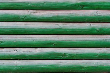background of old weathered and cracked boards with peeling paint of green colorの写真素材