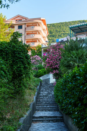 path with stairs surrounded by flowers to beautiful hotel building, city street view and beautiful architectureの写真素材