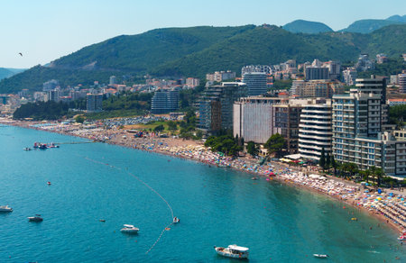 panorama of Becici beach, Montenegro, view of Adriatic sea beach, hotels and yachts and vacationers, summer travel and vacation conceptの写真素材