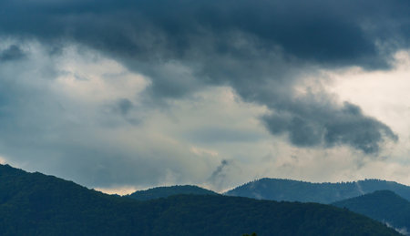 beautiful landscape of Carpathian mountains and forest and cloudy dramatic skyの写真素材