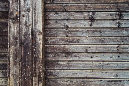 background of old weathered and cracked boards with peeling paint of brown color