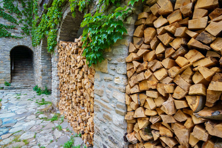 old stone wall with arches and green ivy filled firewood, close up of architectural detailsの写真素材
