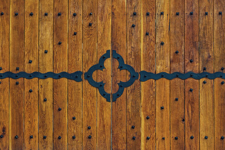 wooden gate close-up with forged elements as an objectの写真素材