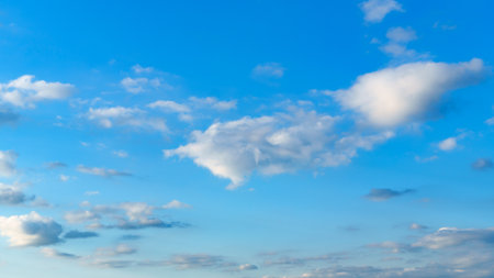 Beautiful blue sky with soft white clouds at dawn for an abstract backgroundの写真素材