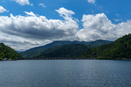 view of lake and hills with forest is beautiful, summer landscape on a bright and sunny dayの写真素材