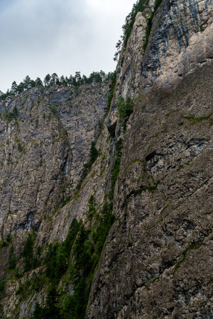 beautiful and dramatic landscape with texture of mountain, and forest against a cloudy skyの写真素材