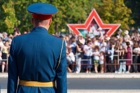 A soldier in formal uniform stands in formation during a parade