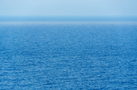 sea surface with small waves as background or texture, bright blue colorの写真素材