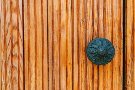 door made of wooden planks with handles, varnished wood in light brown or yellow color as an abstract backgroundの写真素材