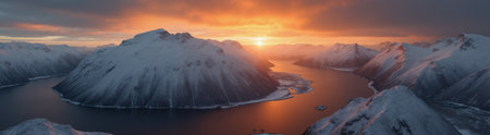 A beautiful northern landscape at sunset, with snow-covered mountains and a lake.の素材