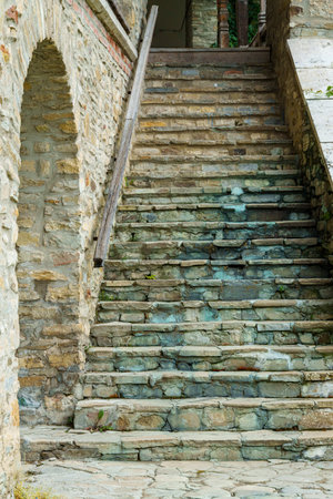 view of stone steps of an old house with arches and porchの写真素材