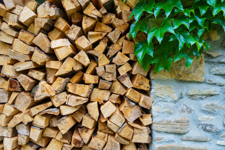 old stone wall with green ivy filled firewood, close up of architectural details