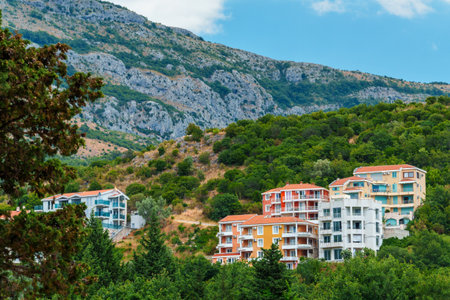 hotels of the resort town against the backdrop of mountains covered with forest, architecture, Petrovac city, Montenegroの写真素材