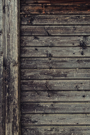 background of old weathered and cracked boards with peeling paint of brown colorの写真素材