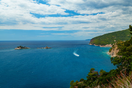View from top of cliff to beautiful Adriatic seascape near Petrovac, Montenegro. Beautiful coast, rock, and island in seaの写真素材
