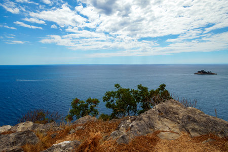 View from top of cliff to beautiful Adriatic seascape near Petrovac, Montenegro. Beautiful coast, rock, and island in seaの写真素材