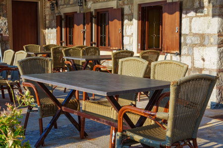cozy outdoor cafe or restaurant located on embankment of Petrovac city, Montenegro, tables and...